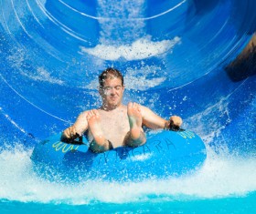 Man playing water slide Stock Photo