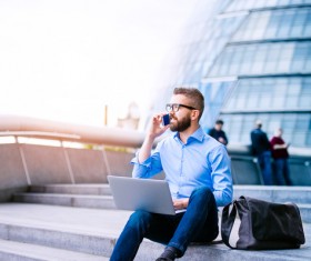Man sitting on the steps talking on the phone Stock Photo