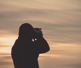 Man taking photo of sunset Stock Photo
