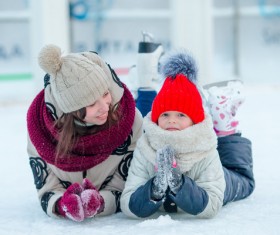 Mother and child lying on the ice Stock Photo
