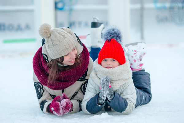 Mother and child lying on the ice Stock Photo