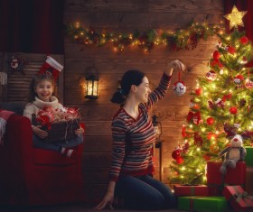 Mother and daughter decorating Christmas tree Stock Photo