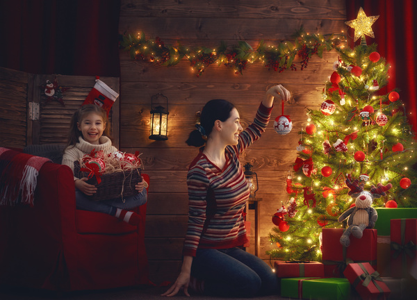 Mother and daughter decorating Christmas tree Stock Photo