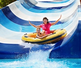 Mother and daughter playing water slides Stock Photo