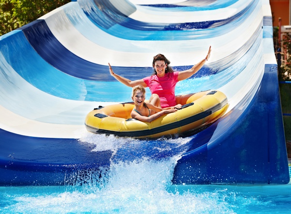 Mother and daughter playing water slides Stock Photo