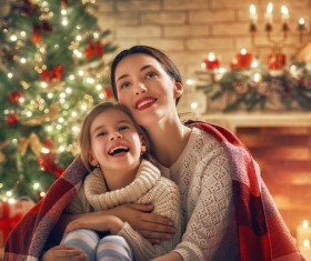 Mother and daughter sitting together on Christmas Eve Stock Photo