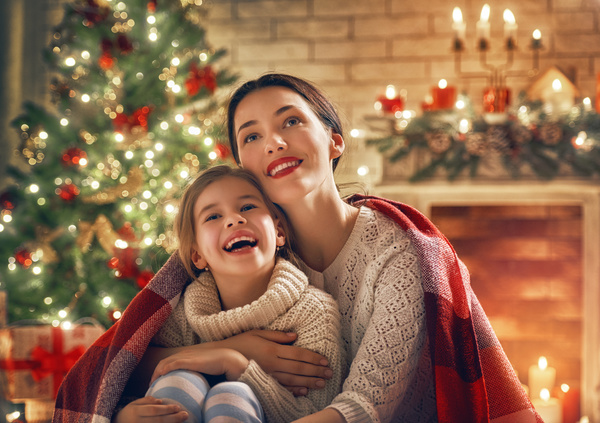 Mother and daughter sitting together on Christmas Eve Stock Photo