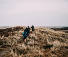 People walking on wild grassland Stock Photo