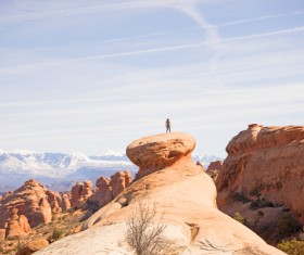 Person standing on rocks landscape Stock Photo