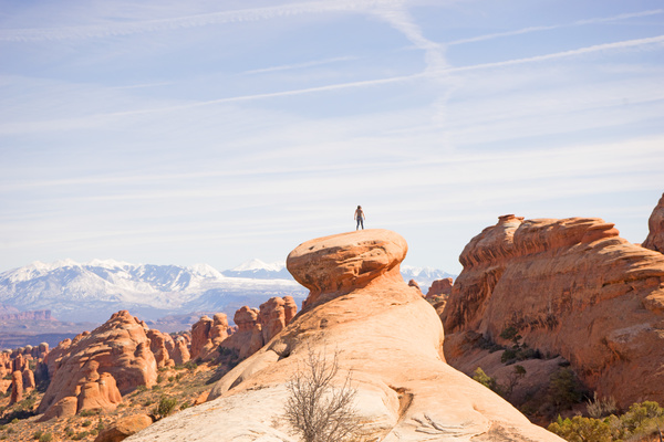 Person standing on rocks landscape Stock Photo