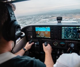 Pilot monitoring helicopter in cabin Stock Photo