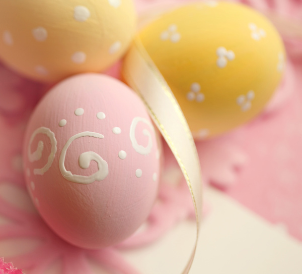 Pink and yellow Easter eggs with ribbons Stock Photo