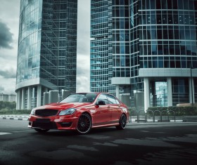 Red car parked in front of building Stock Photo