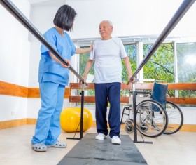 Rehabilitation instructor to guide the elderly exercise Stock Photo