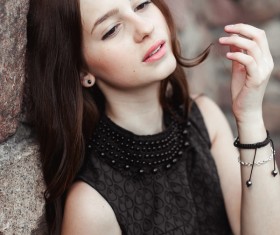 Rely on the wall beautiful young lady Stock Photo 01