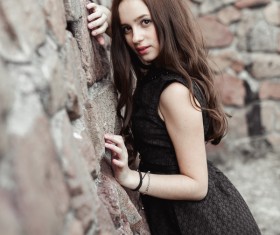 Rely on the wall beautiful young lady Stock Photo 02