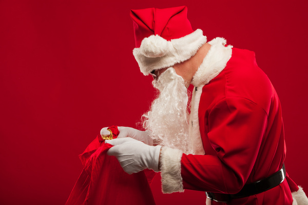 Santa Claus holding Christmas baggage Stock Photo