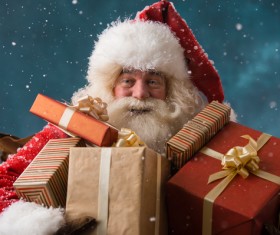 Santa Claus holding a gift Stock Photo
