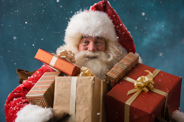 Santa Claus holding a gift Stock Photo