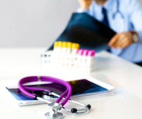 Stethoscope and medical test tube on the desktop Stock Photo