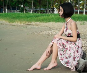 Straight short hair girl sitting on the trunk Stock Photo