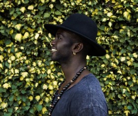 Stylish black man posing with hat Stock Photo