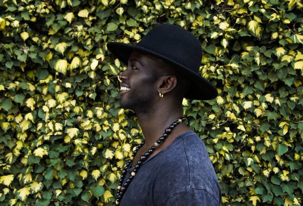 Stylish black man posing with hat Stock Photo
