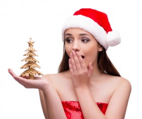 Surprised girl looking at golden Christmas tree in hands Stock Photo