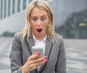 Surprised woman looking sms message Stock Photo