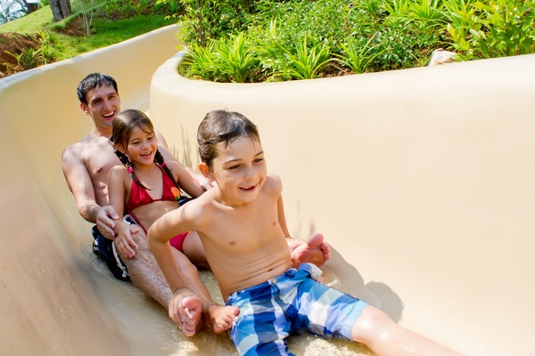 Take the kids play Water slide Father Stock Photo