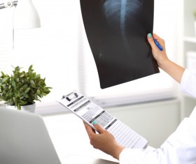 The doctor looks at the patient X-ray Stock Photo 01