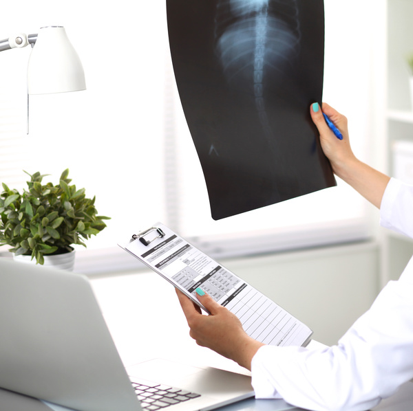 The doctor looks at the patient X ray Stock Photo 01