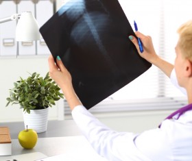 The doctor looks at the patient X-ray Stock Photo 02