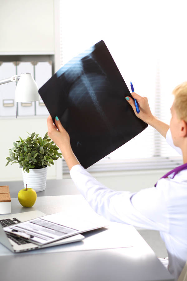 The doctor looks at the patient X ray Stock Photo 02