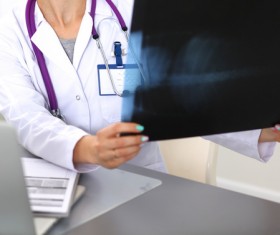 The doctor looks at the patient X-ray Stock Photo 03