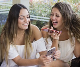Two girls using smartphone Stock Photo