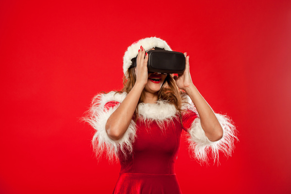 Woman Wearing Christmas Costume Wearing VR Glasses Stock Photo 01