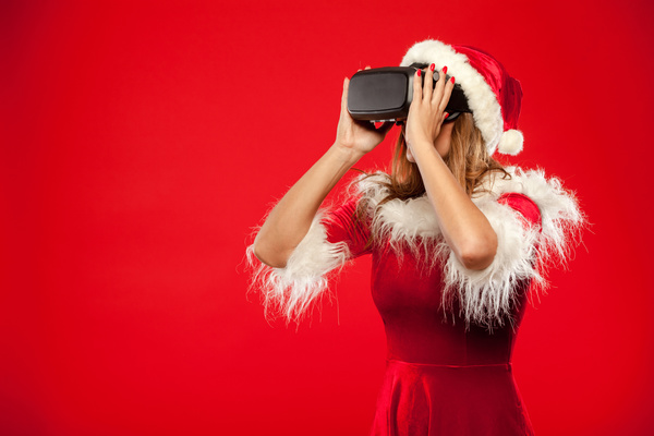 Woman Wearing Christmas Costume Wearing VR Glasses Stock Photo 02