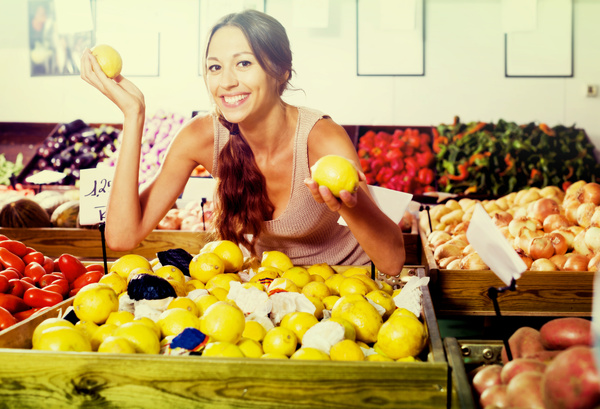 Woman buying lemon Stock Photo