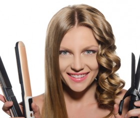 Woman holding a curling perm tool Stock Photo 01