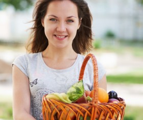 Woman holding fruit basket Stock Photo