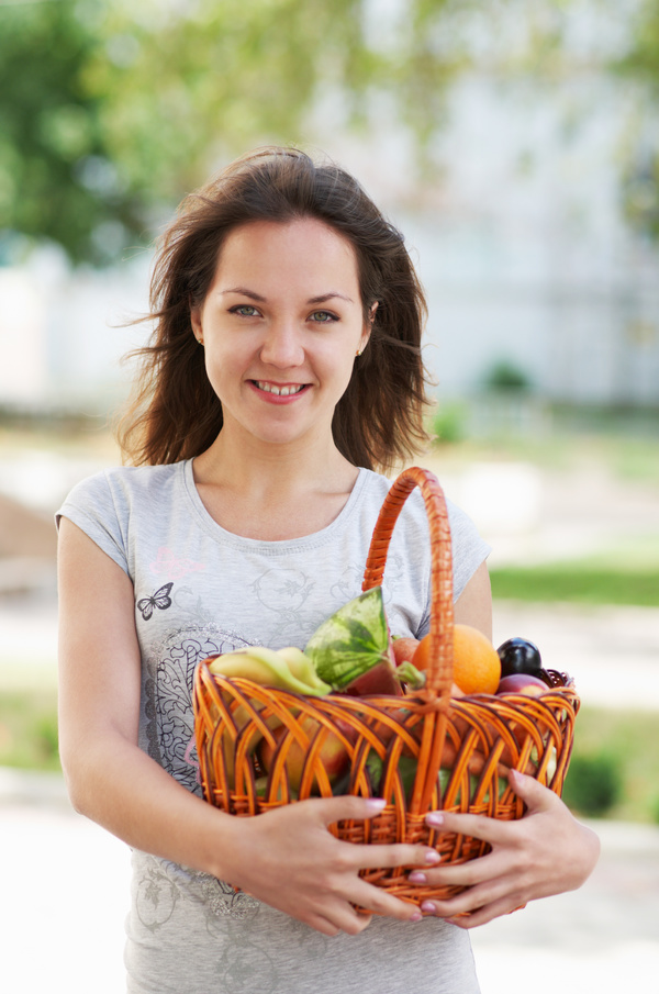 Woman holding fruit basket Stock Photo