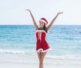 Woman in Christmas dress by the sea Stock Photo