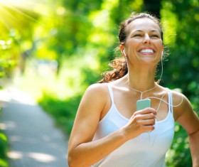 Woman wearing a headset running Stock Photo