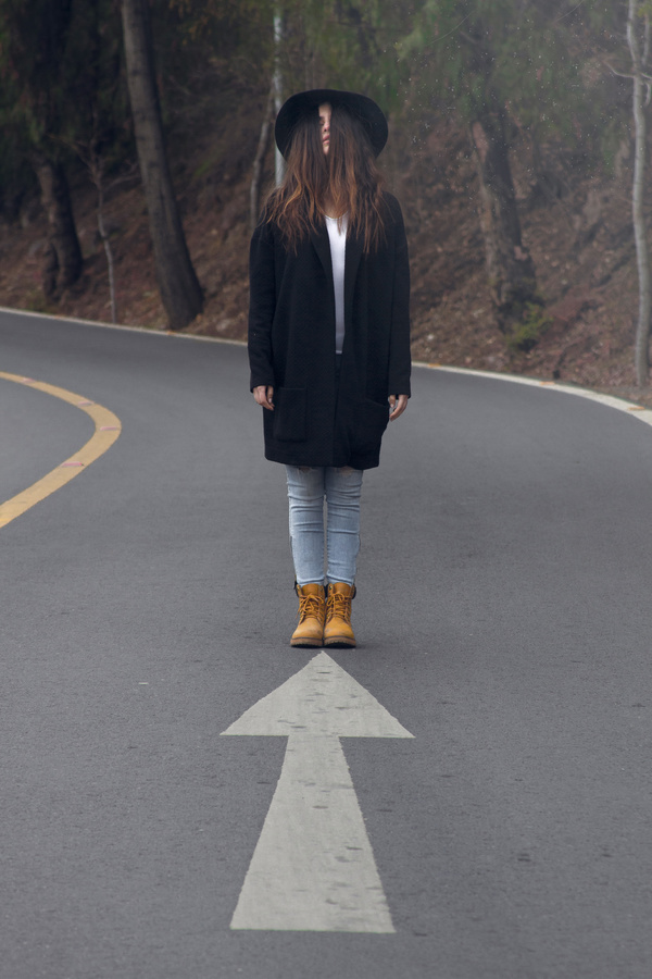 Young woman with scary posing style on road Stock Photo