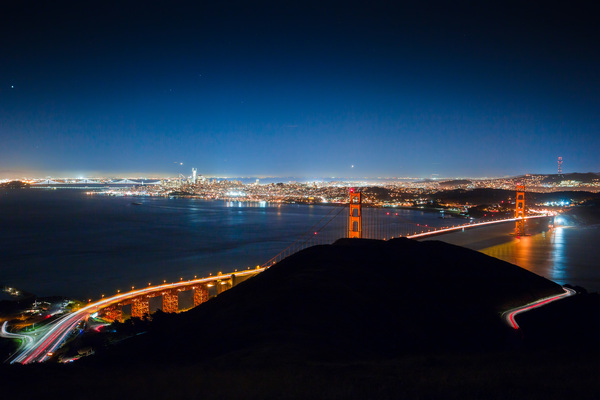 bright bridge in cityscape at night Stock Photo