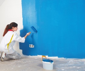 brushing wall Woman Stock Photo
