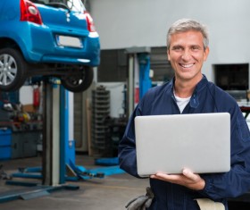 car repairman using laptop Stock Photo