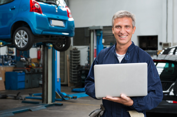 car repairman using laptop Stock Photo