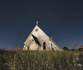 church on grassland at dusk Stock Photo